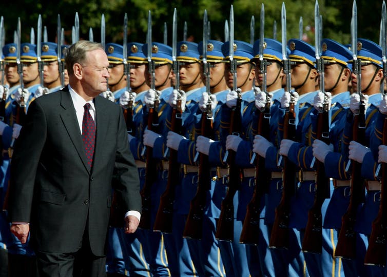 Chretien inspects the honor guard in Beijing.