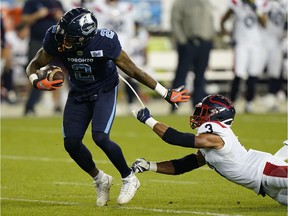 Toronto Argonauts wide receiver Ricky Collins Jr. (2) breaks a tackle from Montreal Alouettes defensive back Patrick Levels (3) after receiving a pass during the first half at BMO Field.