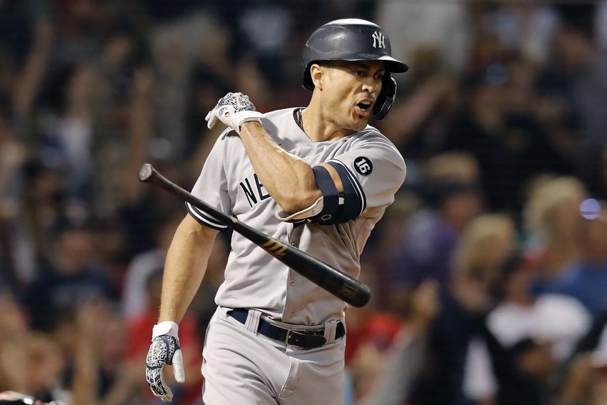 Giancarlo Stanton of the New York Yankees throws his bat after hitting a grand slam during the eighth inning of a baseball game against the Boston Red Sox on Saturday at Fenway Park.