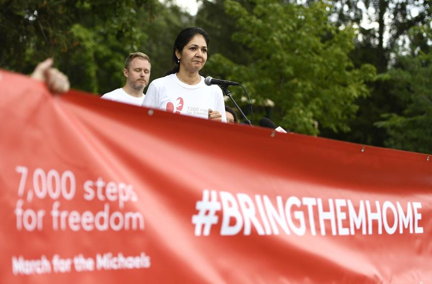 Vina Nadjibulla, wife of Michael Kovrig, stands with Paul Spavor, brother of Michael Spavor, as he speaks before the March for the Michaels, which marks 1,000 days since Canadians Kovrig and Spavor were detained in China, in Ottawa, the Sunday, Sept.  5, 2021.