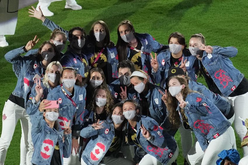 Canadian athletes pose for a photo during the closing ceremony at the Olympic Stadium for the 2020 Summer Olympics.