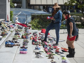 Two hundred and fifteen pairs of children's shoes line the steps of the Vancouver Art Gallery on Friday, May 28, 2021 in response to the revelation that 215 children's remains were discovered this week at the site of the former Kamloops residential school. .