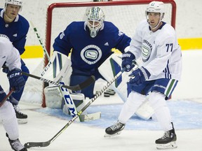 Defender Brad Hunt (right) follows the play off goalie Thatcher Demko on the first official day on ice of the Canucks training ground at the Abbotsford Center in Abbotsford on September 23, 2021.