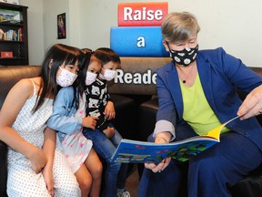 Municipal Affairs Minister Josie Osborne with (from left) Aubrey Trinh, Olivia Trinh and Quinto Hsu.