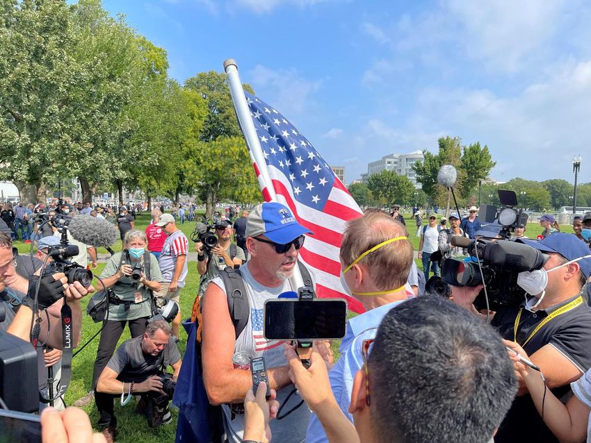 Face-to-face discussions between protesters and counter-protesters quickly drew crowds of observers from the press.