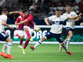 Ricardo Pepi (16) of FC Dallas shoots on goal on Ranko Veselinovic (4) of Vancouver Whitecaps during the first half of an MLS soccer game in Vancouver, Saturday, Sept. 25, 2021.