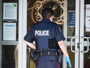 A Toronto police officer prepares to enter a retirement home in Yorkville in this June 2021 file photo.