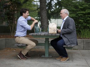 Prime Minister Justin Trudeau and BC Prime Minister John Horgan meet for lunch in the courtyard of the Coquitlam City Hall in Coquitlam, BC on Thursday, July 8, 2021.