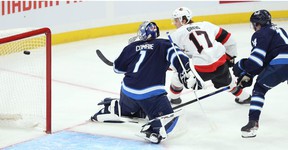 Winnipeg Jets goalkeeper Eric Comrie is defeated by Ottawa Senators forward Ridly Greig in the NHL exhibition game at the Canada Life Center in Winnipeg on Sunday, September 26, 2021.
