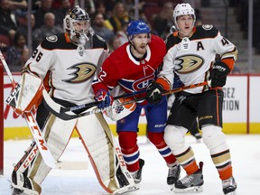 Canadiens 'Dale Weise squeezes between Anaheim Ducks' John Gibson, left, and Josh Manson in Montreal on February 6, 2020.