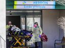 Paramedics remove a resident from CHSLD Herron in Dorval on April 8, 2020.