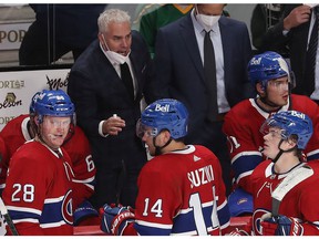 Montreal Canadiens coach Dominique Ducharme talks to his players during an overtime timeout in NHL action in Montreal on Thursday, Oct. 7, 2021.