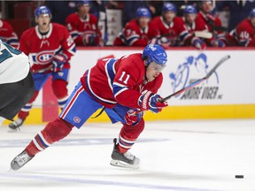 Brendan Gallagher of the Montreal Canadiens eludes a check from Jasper Weatherby of the San Jose Sharks during the third period in Montreal on October 19, 2021.