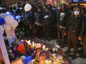 Family and friends hear prayers at a vigil for Jannai Dopwell-Bailey in Montreal on Friday, Oct. 22, 2021.