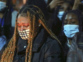 A young woman cries at a vigil for Jannai Dopwell-Bailey in Montreal on Friday, Oct. 22, 2021.