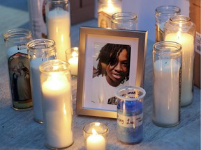 Candles surround a photo of Jannai Dopwell-Bailey at a vigil for him in Montreal on Friday, Oct. 22, 2021.