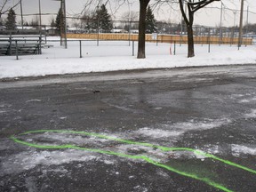 Police markings delineate an area where bloodstains mark the site of a stabbing in Marc Aurèle Fortin Park north of Montreal on Thursday, Jan.2, 2020.