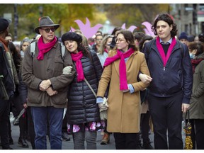 Romane Bonnier's parents and siblings lead a large group of friends and supporters through the McGill Ghetto in Montreal on Saturday, October 30, 2021, on their way to the Rialto Theater for the funeral of the young woman who was stabbed to death in Montreal la last week.