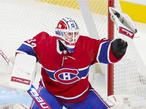 Jake Allen of the Montreal Canadiens makes a glove during the third period against the Carolina Hurricanes in Montreal on October 21, 2021.