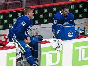 Olli Juolevi (left), seen after a conditioning skid in January before last season, has slipped below Quinn Hughes (right) in the Canucks' defensive pecking order.  Vancouver is said to be buying it from the league.