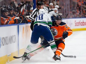 Tyson Barrie of the Edmonton Oilers collides with Tanner Pearson of the Vancouver Canucks during the first period at Rogers Place on October 13, 2021 in Edmonton, Canada.