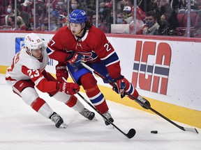 Alexander Romanov of the Canadiens skates the puck against Lucas Raymond of the Detroit Red Wings during the first period at the Bell Center on Saturday, Oct. 23, 2021, in Montreal.