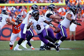 Baltimore Ravens quarterback Lamar Jackson comes out of pocket in the second half of the game against the Broncos at Empower Field At Mile High on October 3, 2021 in Denver.