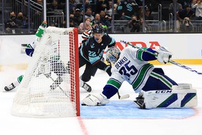 Thatcher Demko leans back to make a save on a dripping puck, one of several spectacular saves that kept the Canucks in the game in the second.