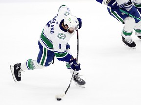 Conor Garland of the Vancouver Canucks shoots against the Seattle Kraken.