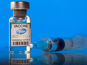 This illustration image taken on March 19, 2021 shows a vial labeled with the Pfizer-BioNTech coronavirus disease (COVID-19) vaccine.
