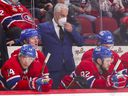Canadiens head coach Dominique Ducharme adjusts his mask while standing behind Nick Suzuki, from left, Tyler Toffoli, Jonathan Drouin and Christian Dvorak during the third period of Tuesday's 5-0 loss to the Sharks at the Bell Center.