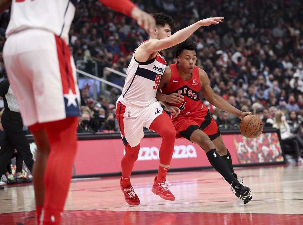 Raptors forward Scottie Barnes leans into the Washington Wizards' Deni Avdija during his NBA debut.  Barnes finished with 12 points.