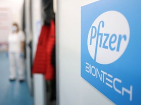 A healthcare worker waits in front of a booth where people receive doses of Pfizer's COVID-19 vaccine at the Belgrade Fair vaccination center in Belgrade, Serbia, on October 15, 2021.