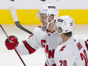 Jesperi Kotkaniemi of the Hurricanes celebrates his goal in the third period with teammate Sebastian Aho on Thursday night at the Bell Center.  Kotkaniemi signed a $ 6.1 million contract with Carolina during the offseason.