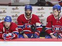 Jonathan Drouin, Mathieu Perreault and Josh Anderson of the Montreal Canadiens remain on the bench after the final siren in their loss to the Carolina Hurricanes in Montreal on October 21, 2021. 