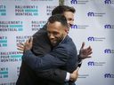 Balarama Holness of Movement Montreal and Marc-Antoine Desjardins, left, of Ralliement pour Montréal, hug in front of Montreal City Hall on Thursday, when they announced that their parties are allying themselves.