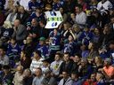 Vancouver Canucks fans cheer for their team during a preseason game against the Calgary Flames in Victoria on September 16, 2019. Once again, full capacity is allowed at all sporting events in BC