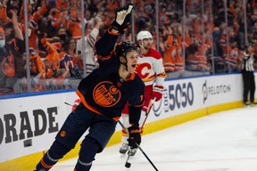 Edmonton Oilers' Jesse Puljujarvi (13) celebrates a goal over Calgary Flames goalkeeper Jacob Markstrom (25) during NHL third period action at Rogers Place in Edmonton, Saturday, Oct. 16, 2021.