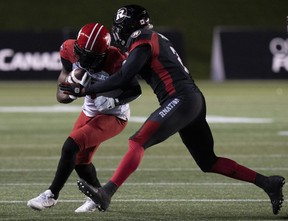 Ottawa Redblacks defensive back Randall Evans tackles Calgary Stampeders wide receiver Hergy Mayala while running with the ball last night at TD Place.