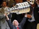 Chicago Blackhawks head coach Joel Quenneville celebrates by lifting the Stanley Cup after defeating the Tampa Bay Lightning 2-0 in Game 6 to win the 2015 Stanley Cup final at the United Center on June 15, 2015 in Chicago