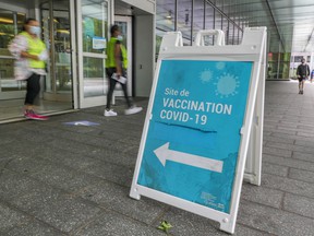 The women leave the COVID-19 vaccination clinic at the Palais des Congrès in Montreal on Thursday, August 19, 2021.