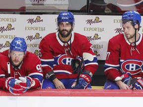 Jonathan Drouin, Mathieu Perreault and Josh Anderson of the Canadiens remain on the bench after the final siren in their loss to the Carolina Hurricanes in Montreal on October 21, 2021.