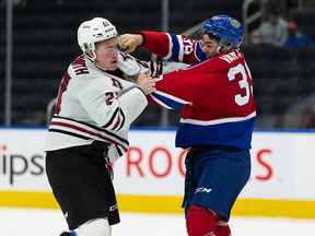 Shea Van Olm (39) of Edmonton Oil Kings battles Joel Sexsmith (27) of Red Deer Rebels during second period WHL action at Rogers Place in Edmonton on Sunday, Oct. 17, 2021. Photo by Ian Kucerak