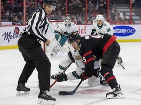 Senators center Josh Norris faces Sharks forward Tomas Hertl in the circle head-to-head during the first period of Thursday's game at the Canadian Tire Center.