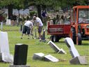 Windsor Memorial Gardens workers Ken Major, left, and Joe Mizzi are doing their best to keep up with headstone repair at Windsor Grove Cemetery on Friday.  
