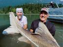 Jake Driedger (left) and Pete Peeters with the huge sturgeon they captured with the help of guide Kevin Estrada in the Fraser River near Chilliwack on August 15.