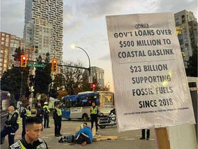 Several climate protesters were arrested Friday night after chaining themselves to a concrete block at the intersection of Burrard and Pacific streets in Vancouver.