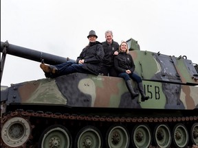 Sean Rayner, the president of the fourth generation company of the VETS Group, on the left, his father David Rayner, the president of the third generation.  and daughter and marketer Erin Rayner, a member of the company's fourth generation, in an M109 howitzer on the 15th hole of the Edmonton Garrison Memorial Golf and Curling Club.  Photo supplied / Moments in digital photography