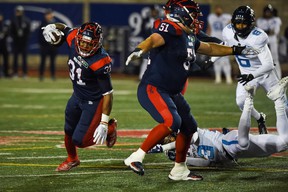 Alouettes running back William Stanback avoids an Argonauts' Jeff Richards tackle in the second quarter during a Canadian Football League game at Molson Stadium.