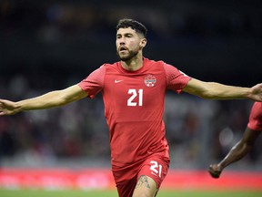 Canada's Jonathan Osorio celebrates after scoring against Mexico during the Concacaf qualifying match for the Qatar 2022 FIFA World Cup Qatar at the Azteca Stadium in Mexico City on October 7, 2021.